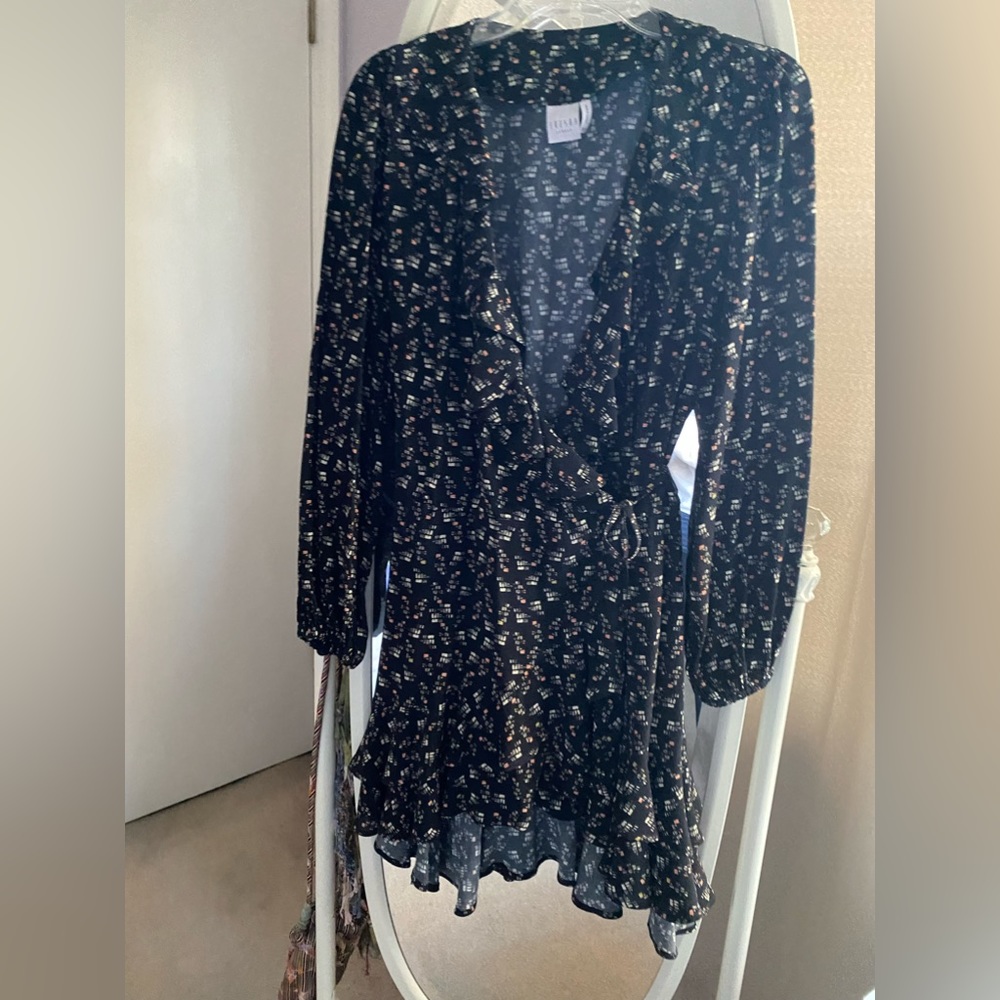 Wrap ruffle hemmed mini dress. In excellent condition. Very fun and comfortable.
